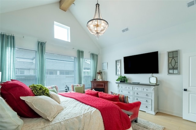 bedroom featuring beamed ceiling, light wood-type flooring, high vaulted ceiling, and an inviting chandelier