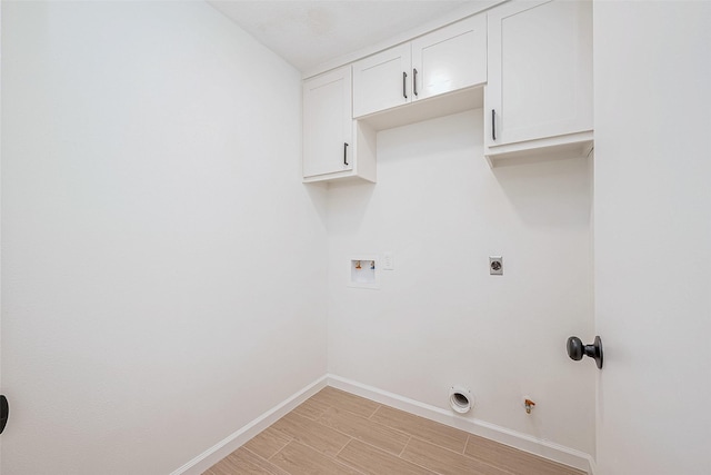 washroom with gas dryer hookup, cabinets, electric dryer hookup, washer hookup, and light hardwood / wood-style floors