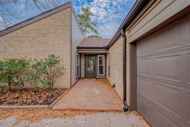 view of exterior entry featuring a garage