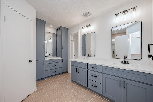 bathroom featuring vanity and a textured ceiling