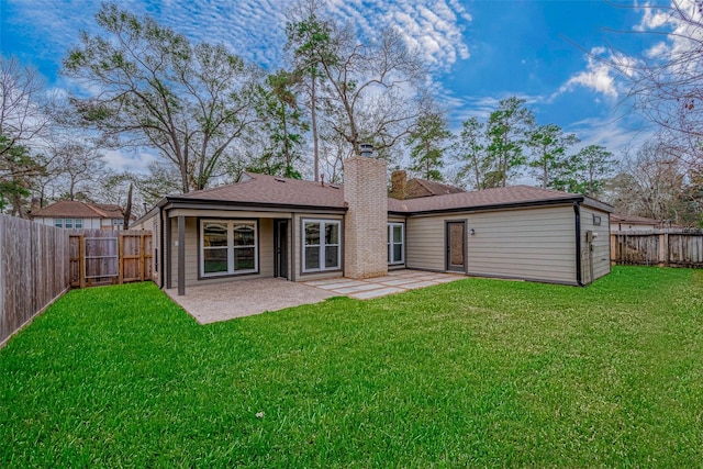 rear view of property with a patio area and a lawn