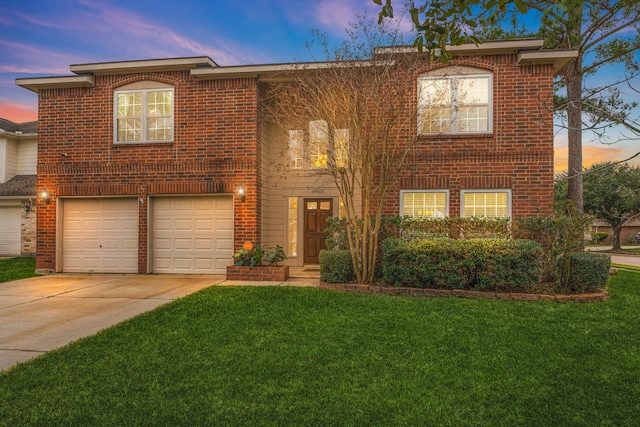 view of front of home featuring a yard, brick siding, an attached garage, and driveway