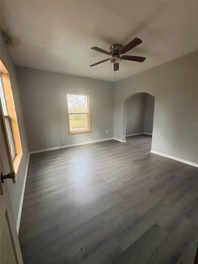 unfurnished room featuring ceiling fan and dark hardwood / wood-style flooring