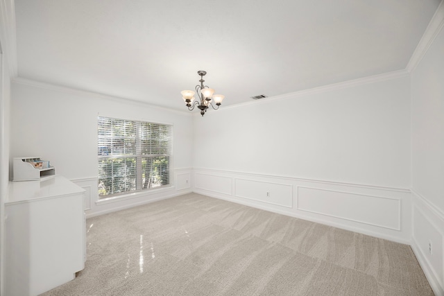 empty room featuring light carpet, a notable chandelier, and ornamental molding