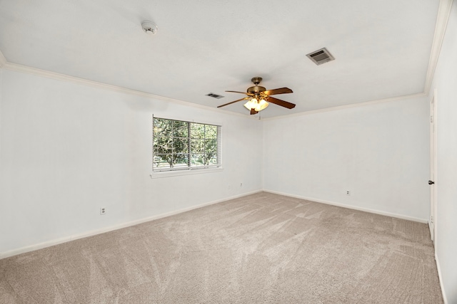 empty room with visible vents, a ceiling fan, ornamental molding, carpet floors, and baseboards