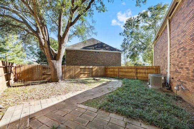 view of yard featuring central AC and a fenced backyard