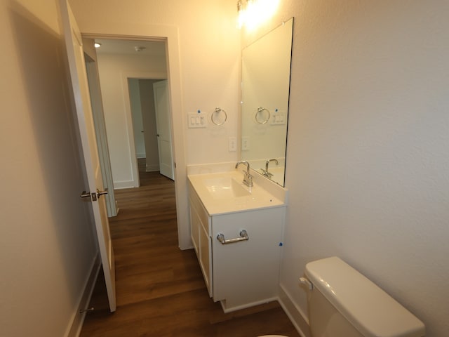 9811 Robard Ridge Ct, Montgomery, TX 77316 - bathroom with wood finished floors, vanity, toilet, and baseboards