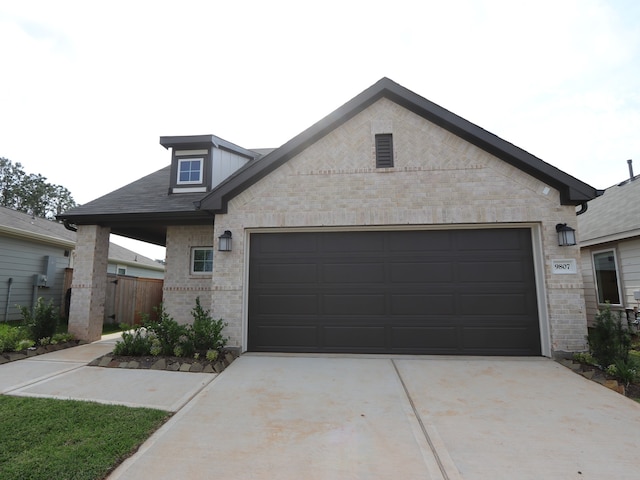 9811 Robard Ridge Ct, Montgomery, TX 77316 - view of front of house with concrete driveway, brick siding, and a garage