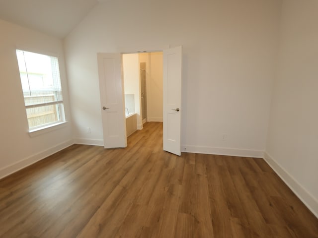 9811 Robard Ridge Ct, Montgomery, TX 77316 - empty room with wood finished floors, lofted ceiling, and baseboards