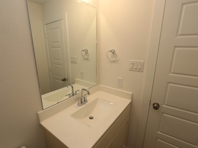 26235 Astral Way, La Marque, TX 77568 - bathroom featuring vanity and a textured wall