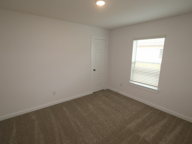 26235 Astral Way, La Marque, TX 77568 - empty room with dark carpet and baseboards