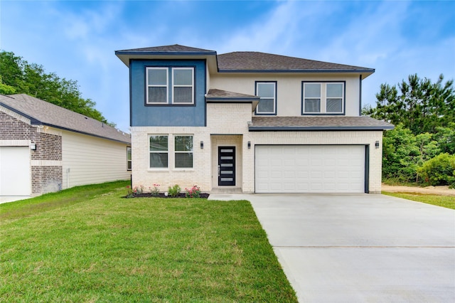 view of front facade with a garage and a front lawn