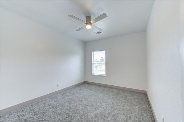 empty room with ceiling fan and carpet flooring