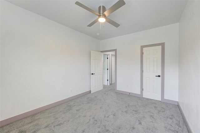 spare room featuring light carpet and ceiling fan