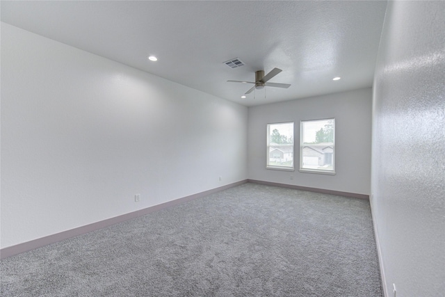 carpeted spare room with ceiling fan