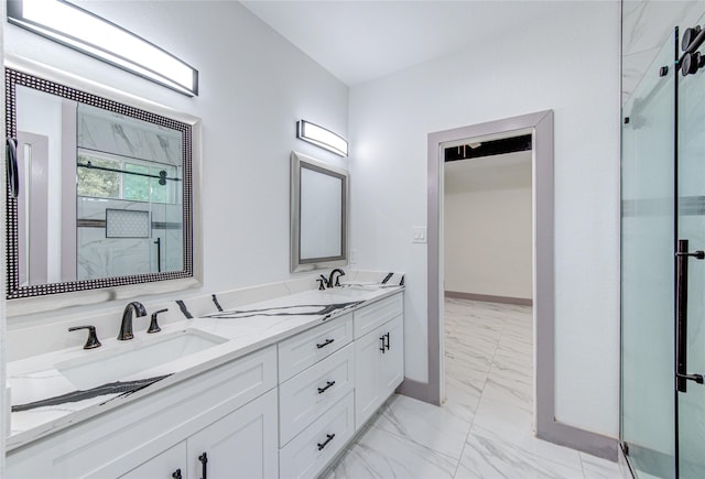 bathroom featuring a shower with door and vanity