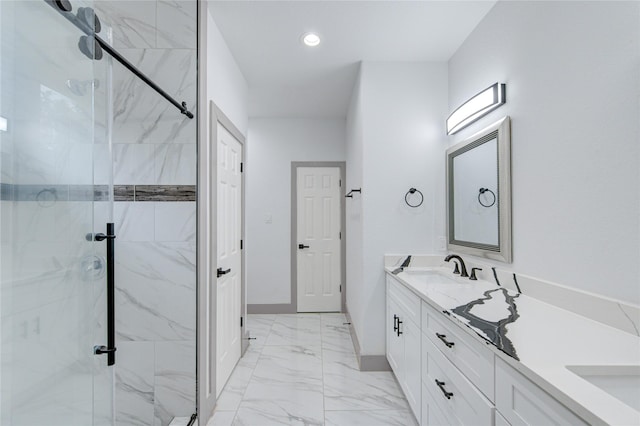 bathroom with vanity and a shower with shower door