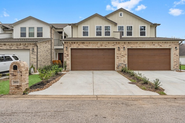 multi unit property featuring driveway, board and batten siding, and an attached garage