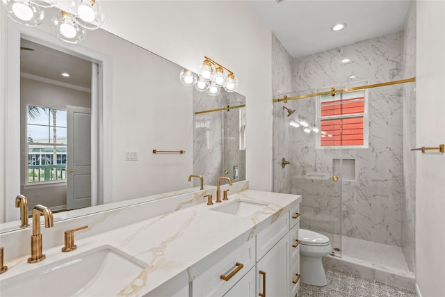 bathroom featuring a shower with door, vanity, and toilet