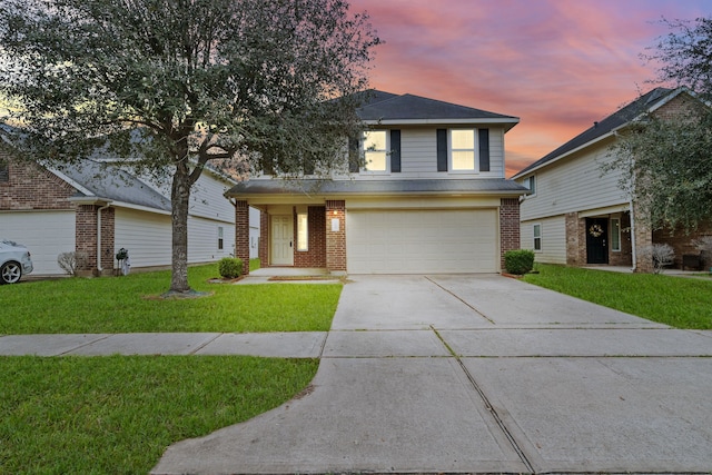 view of property featuring a garage and a yard