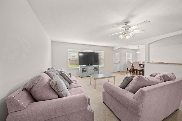 carpeted living room with ceiling fan