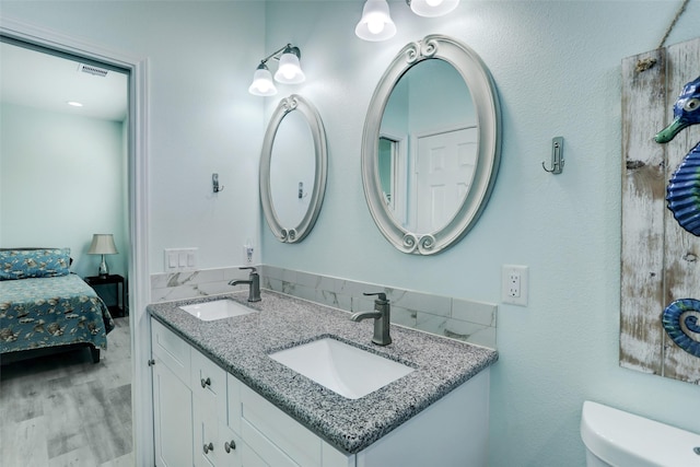 bathroom with vanity, wood-type flooring, and toilet