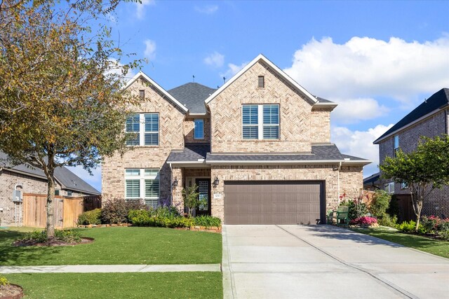 view of front of home featuring a garage and a front lawn