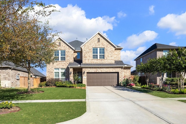 view of front of property featuring a garage and a front yard