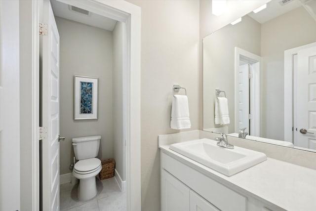 bathroom with tile patterned floors, vanity, and toilet