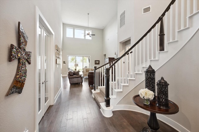 foyer with wood-type flooring and a high ceiling