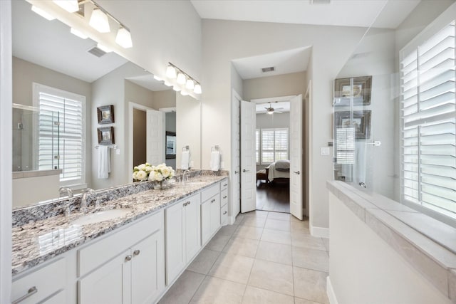 bathroom featuring tile patterned flooring, vanity, lofted ceiling, and ceiling fan