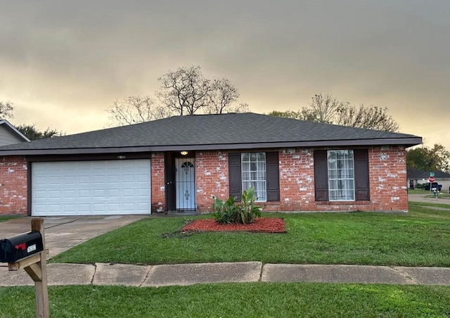 ranch-style house featuring a yard and a garage