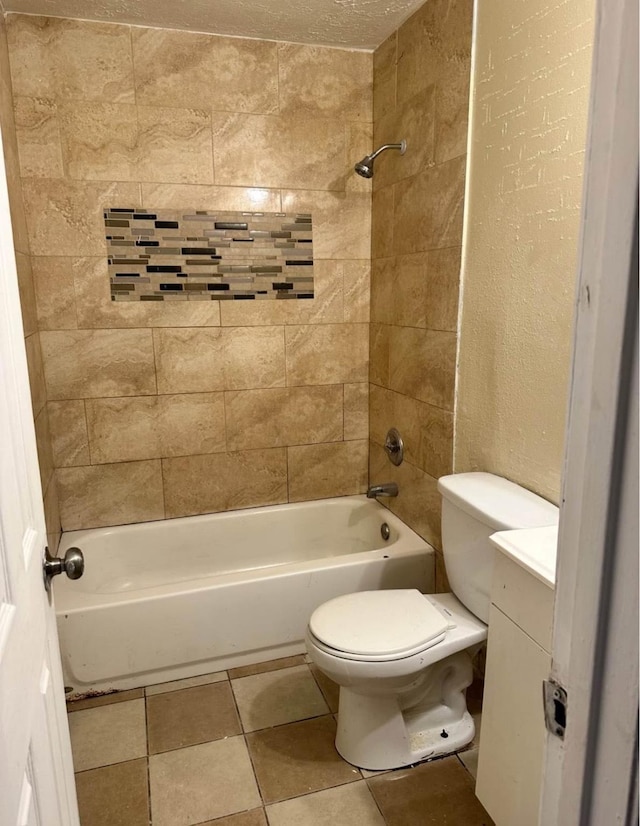 full bathroom with vanity, tiled shower / bath, tile patterned flooring, and toilet