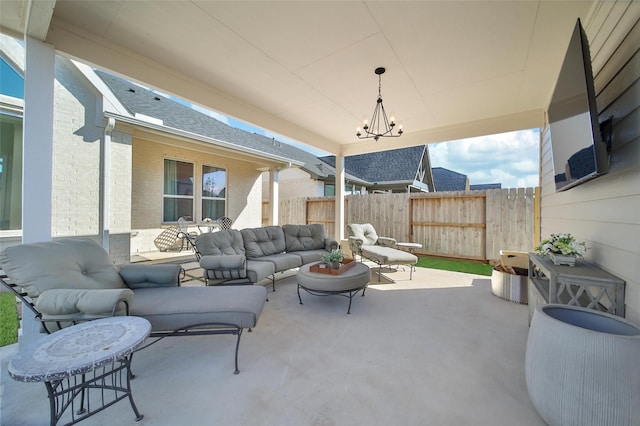 view of patio featuring outdoor lounge area and fence