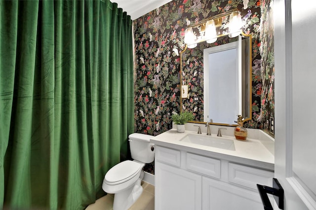 full bathroom featuring toilet, vanity, and wallpapered walls