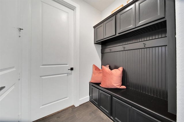 mudroom with dark wood-style floors and baseboards