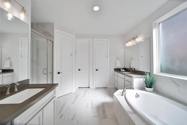 bathroom featuring marble finish floor, a shower stall, two vanities, and a sink