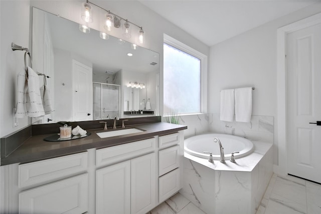 full bath with marble finish floor, vanity, a bath, and a stall shower