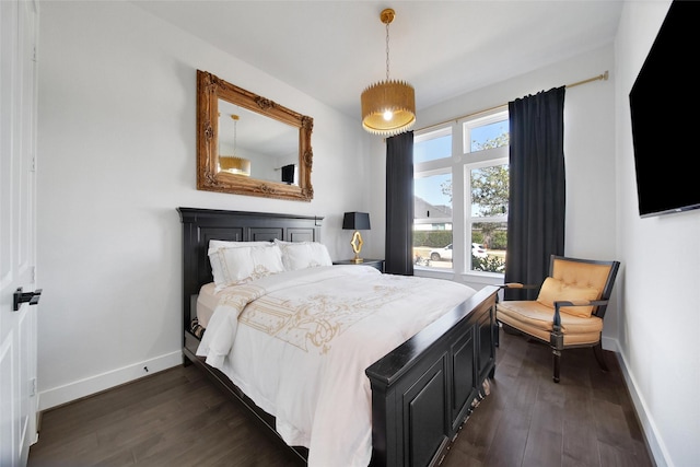 bedroom featuring dark wood-style floors and baseboards