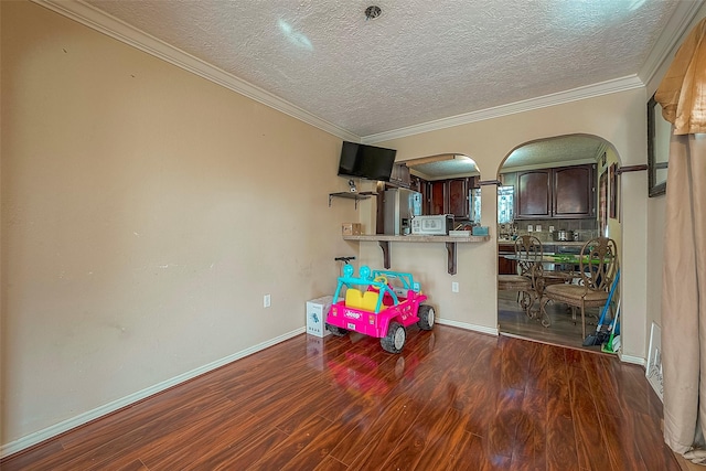 1814 Mansfield St, Houston, TX 77091 - recreation room featuring dark hardwood / wood-style flooring, ornamental molding, and a textured ceiling