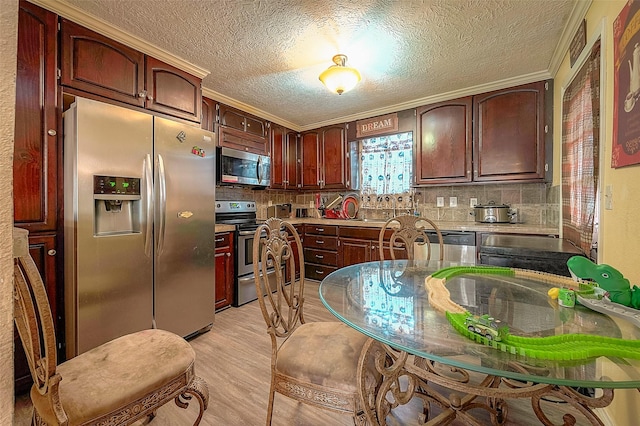 1814 Mansfield St, Houston, TX 77091 - kitchen featuring tasteful backsplash, stainless steel appliances, sink, and light hardwood / wood-style flooring