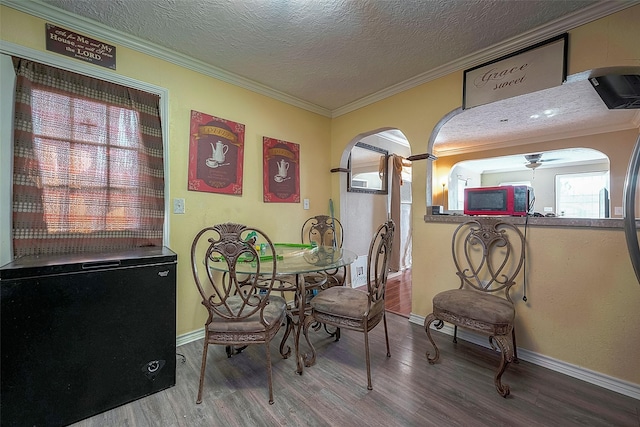 1814 Mansfield St, Houston, TX 77091 - dining area featuring wood-type flooring, a textured ceiling, and crown molding