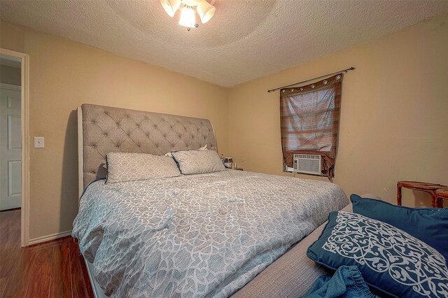 1814 Mansfield St, Houston, TX 77091 - bedroom with cooling unit, dark hardwood / wood-style floors, and a textured ceiling