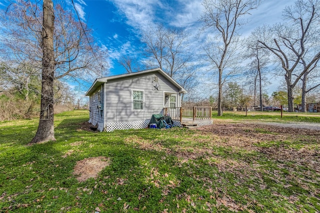 view of property exterior featuring a deck and a lawn