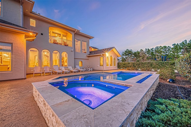 view of pool featuring a fenced in pool, a patio area, and an in ground hot tub