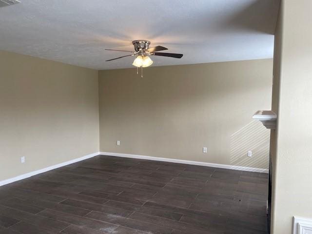 unfurnished room with dark wood-type flooring and ceiling fan