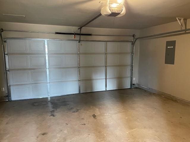 garage with a garage door opener and electric panel