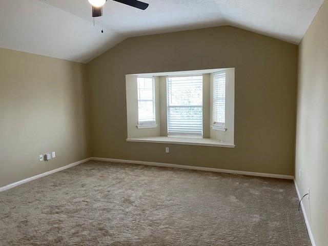 bonus room with lofted ceiling, ceiling fan, and carpet flooring