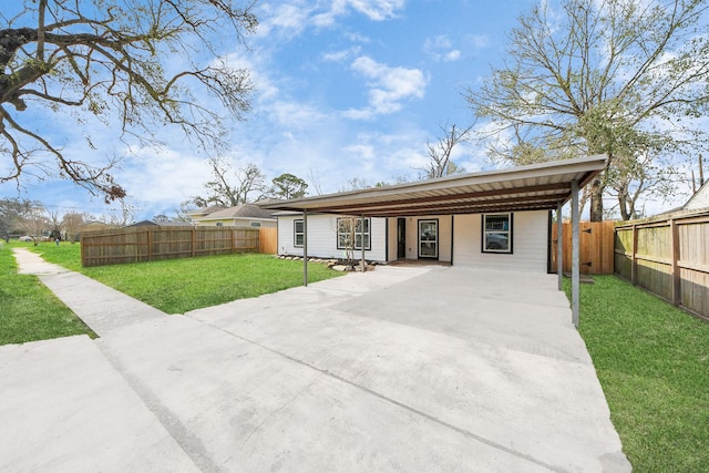 ranch-style home featuring a front yard and a carport