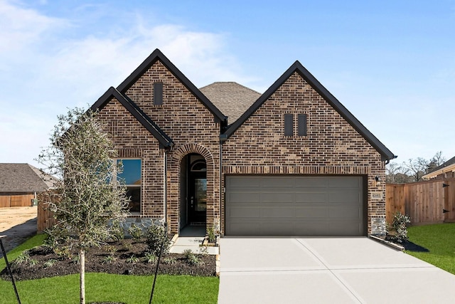 view of front of property featuring brick siding, a shingled roof, fence, concrete driveway, and a garage